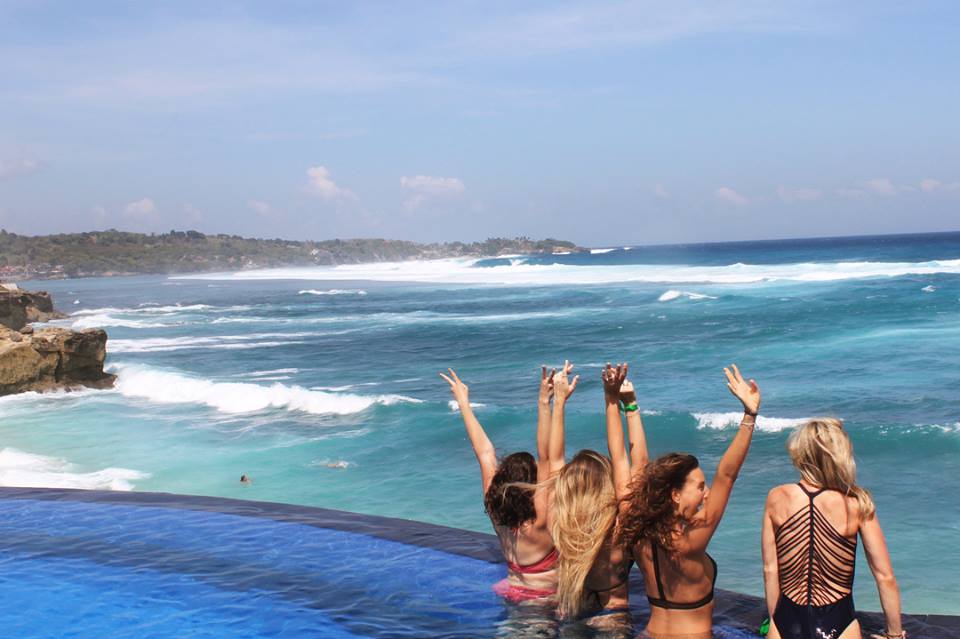 santosha yoga teacher training students in pool with beach in background