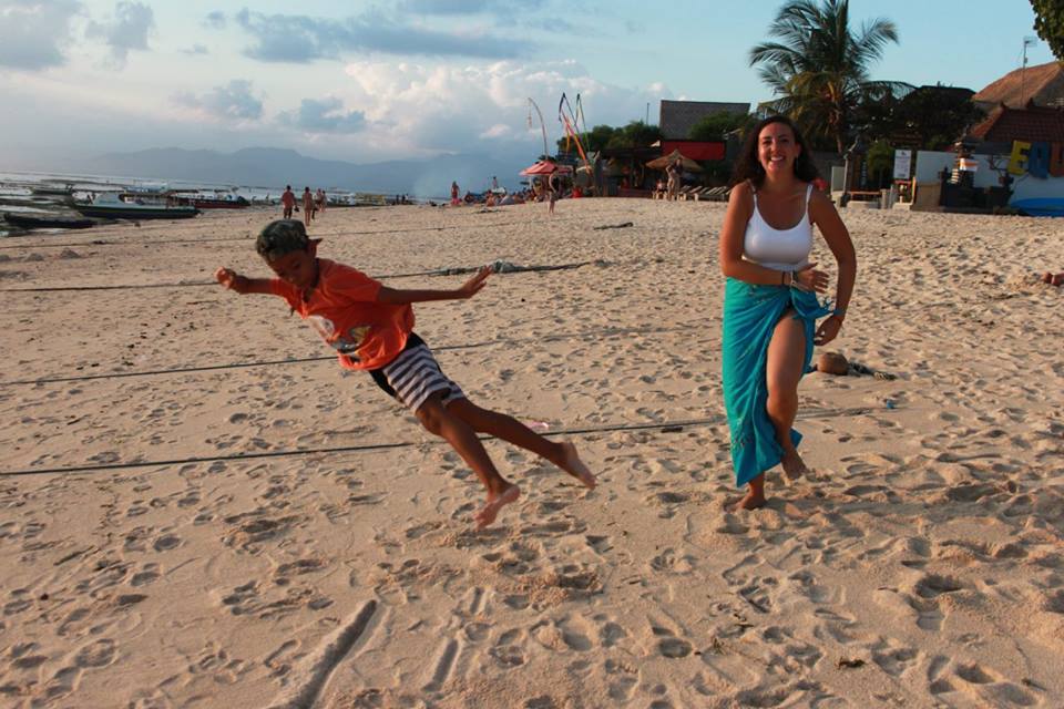 santosha yoga teacher training student on beach with kid