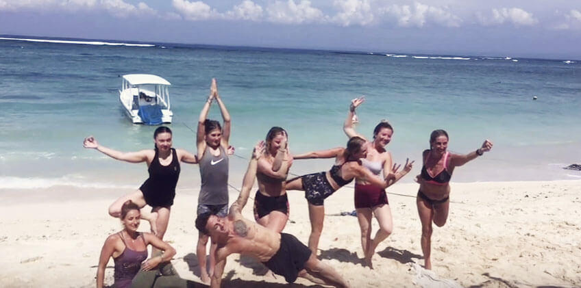 santosha yoga teacher training students doing yoga on beach nusa lembongan